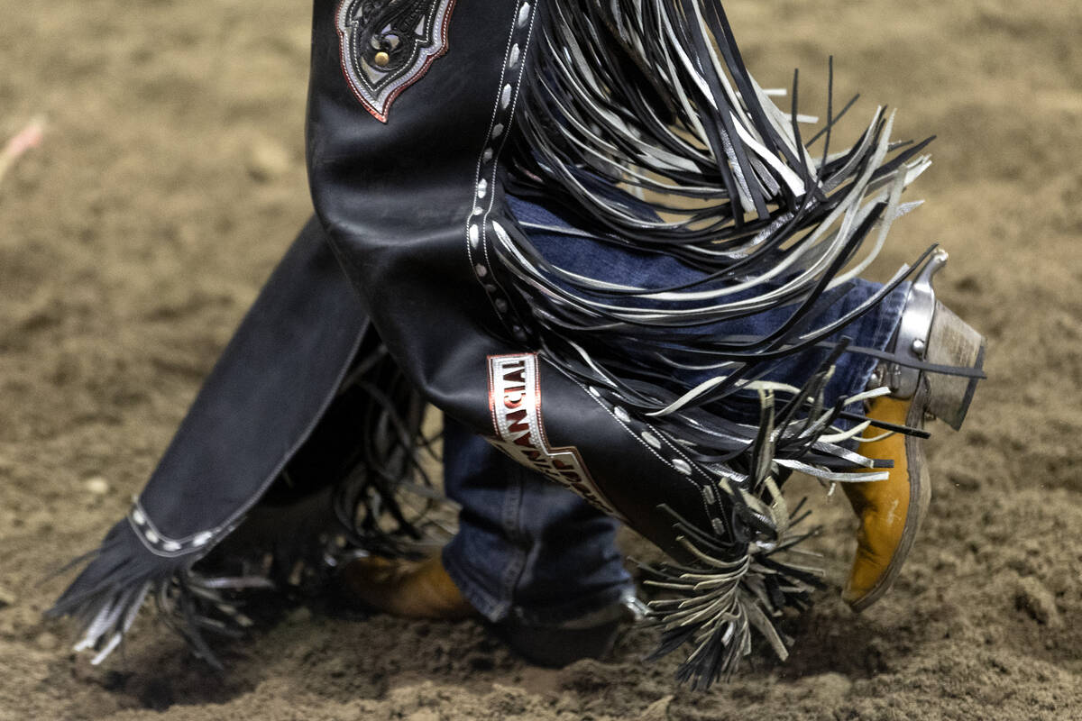 Dawson Hay, of Wildwood, Alberta, Canada, walks from the stage after competing in saddle bronc ...