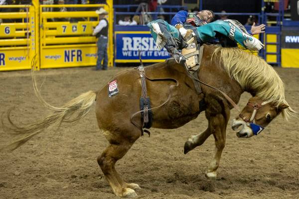 Caleb Bennett, of Corvallis, Mont., competes in bareback riding during the sixth go-round of th ...