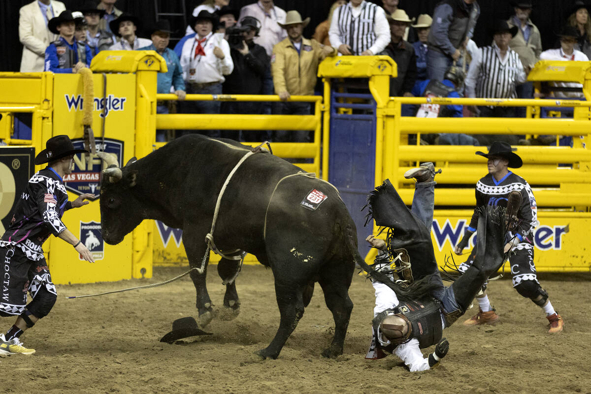 Cole Fischer, of Jefferson City, Mo., is thrown from his bull while competing in bull riding du ...