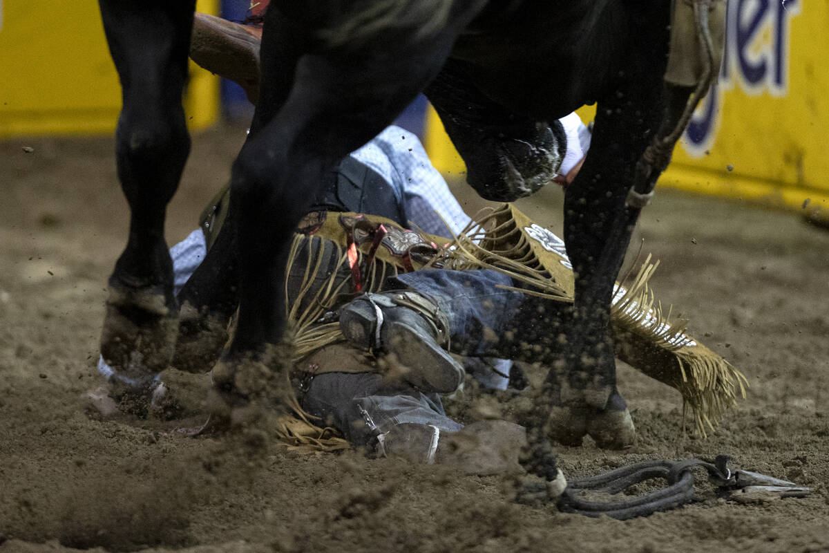 Garrett Smith, of Rexburg, Idaho, is thrown from his bull while competing in bull riding during ...
