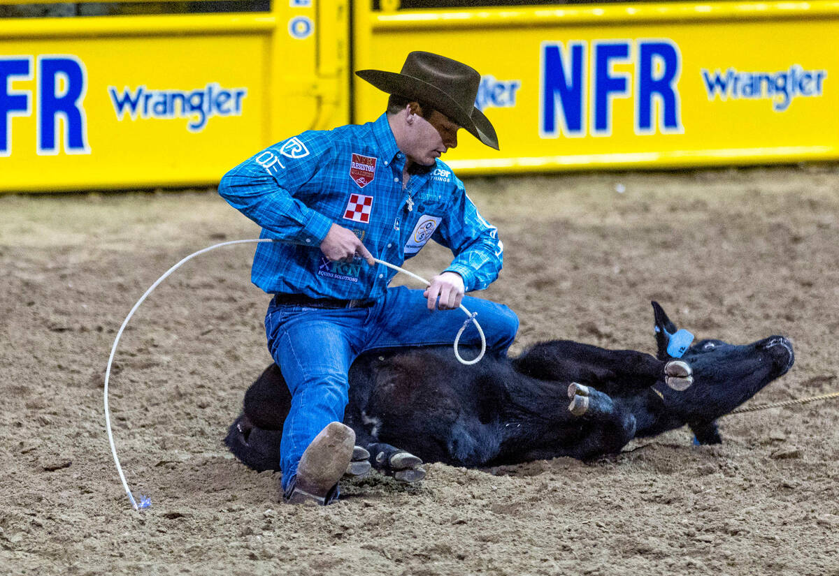 Macon Murphy of Keatchie, LA., lreadies his rope during Tie-Down Roping in the National Finals ...