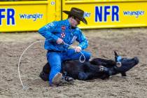 Macon Murphy of Keatchie, LA., lreadies his rope during Tie-Down Roping in the National Finals ...