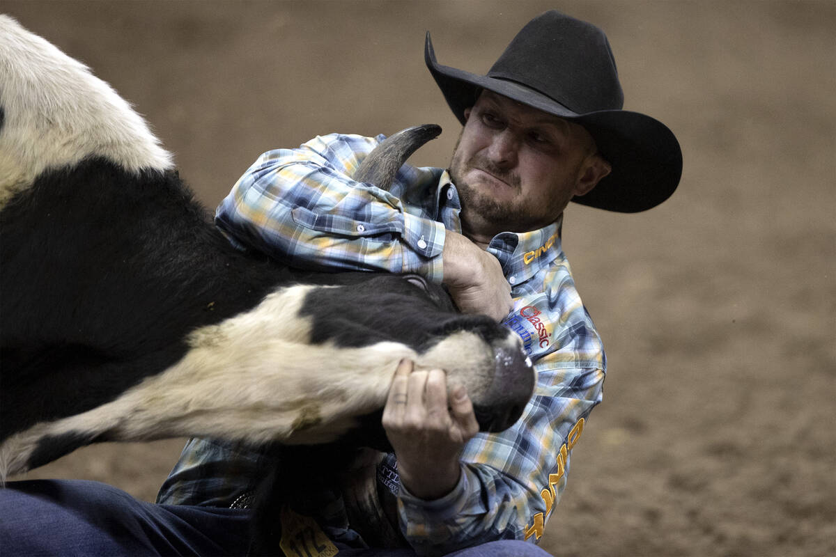 Kyle Irwin, of Robertsdale, Ala., competes in steer wrestling during the sixth go-round of the ...