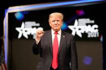 Former president Donald Trump raises his fist before speaking at the Conservative Political Act ...