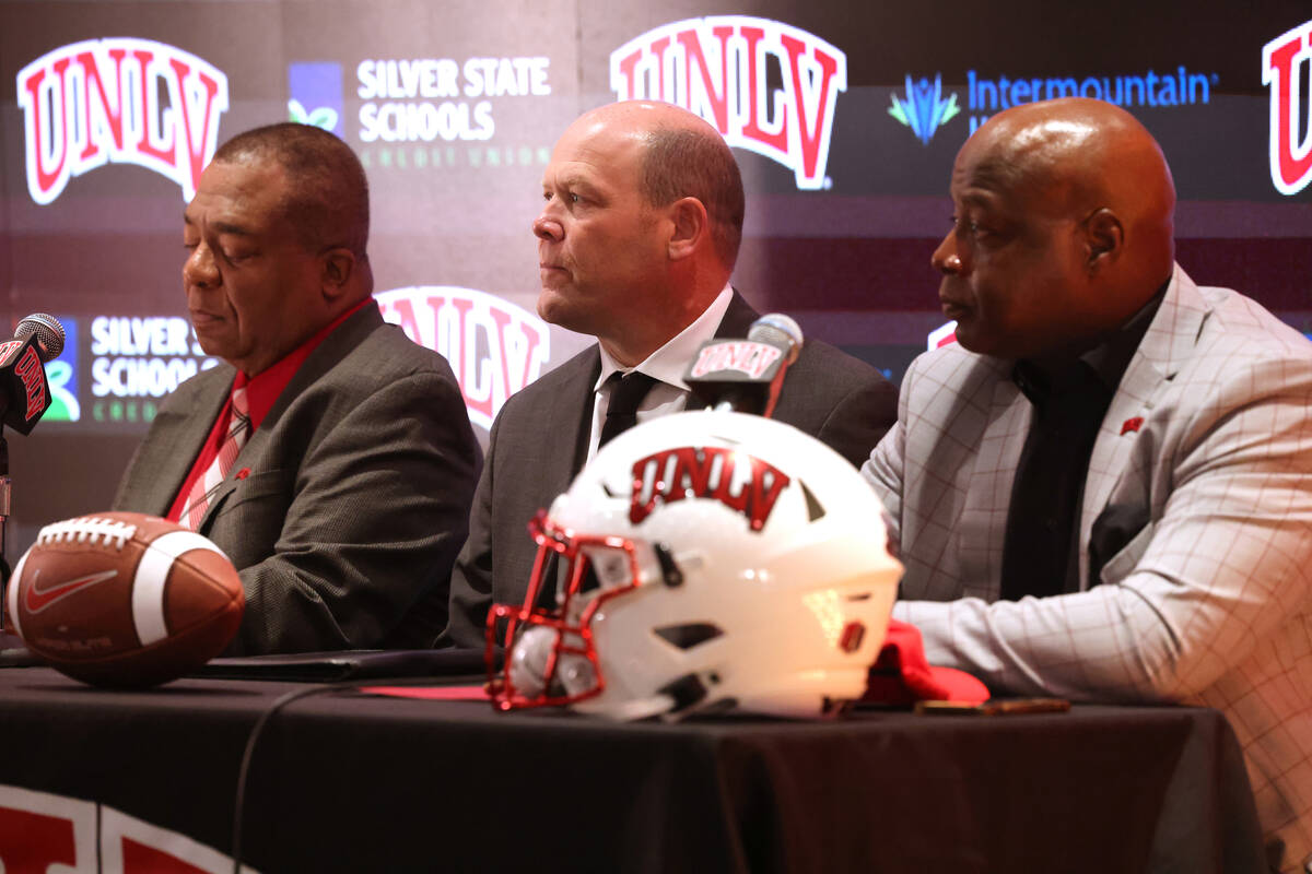 New UNLV football coach Barry Odom, center, is introduced with President Keith Whitfield, left, ...
