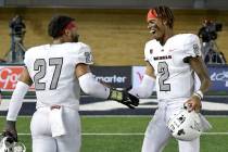 UNLV linebacker Austin Ajiake (27) celebrates with quarterback Doug Brumfield (2) after UNLV de ...