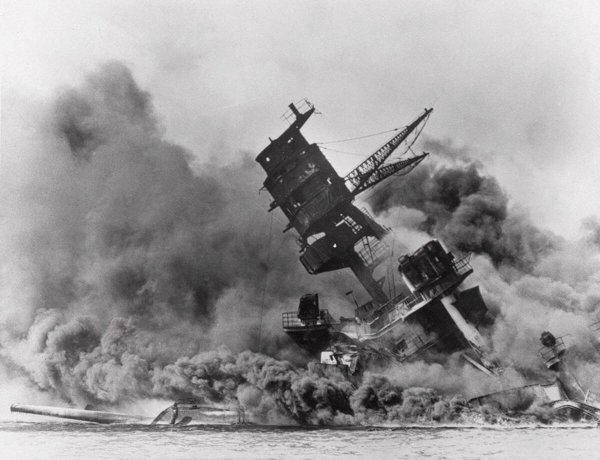 FILE - The battleship USS Arizona belches smoke as it topples over during a Japanese surprise a ...