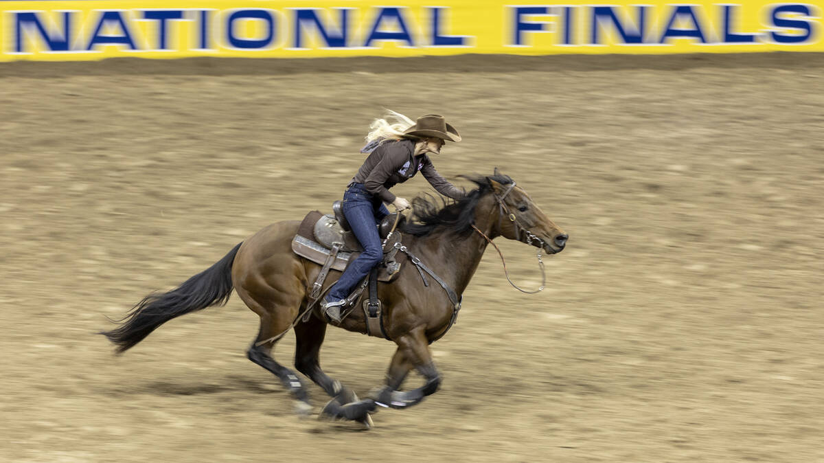 Wenda Johnson, of Pawhuska, Okla., competes in barrel racing during the seventh go-round of the ...