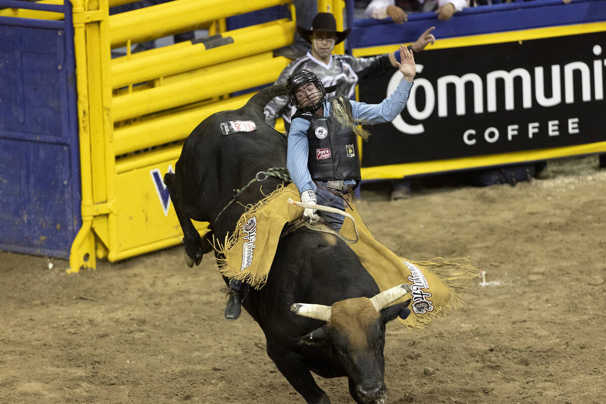 Trevor Kastner, of Roff, Okla., competes in bull riding during the seventh go-round of the Nati ...