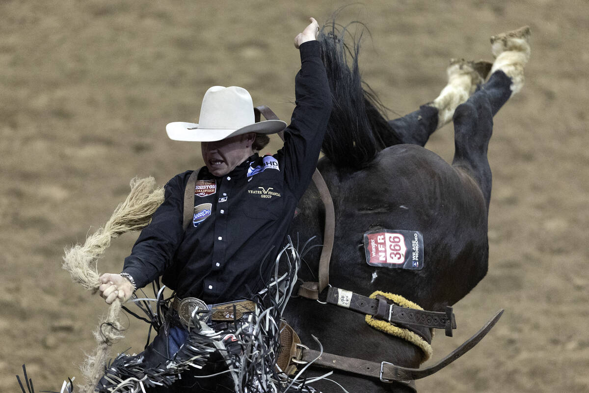 Dawson Hay, of Wildwood, Alberta, Canada, competes in saddle bronc riding during the seventh go ...