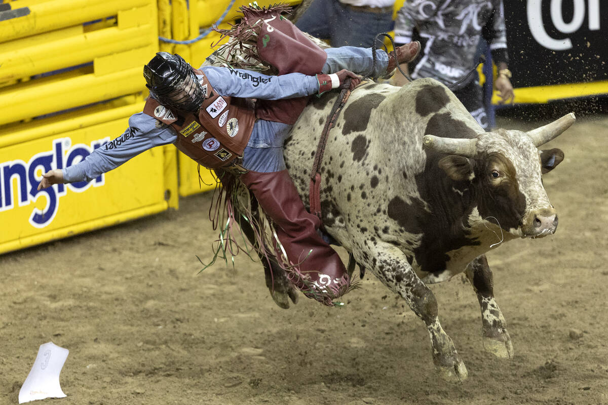 Josh Frost, of Randlett, Utah, competes in bull riding during the seventh go-round of the Natio ...