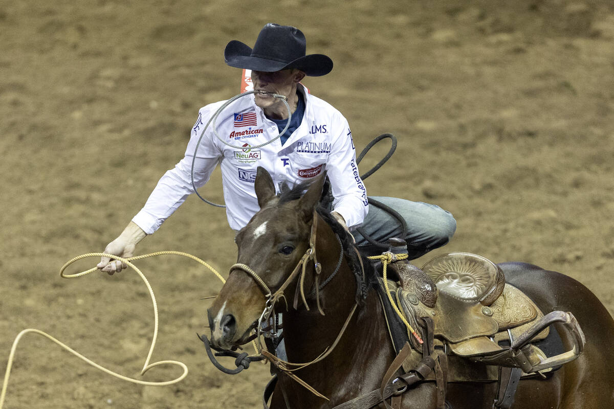 Tuf Cooper, of Decatur, Tex., competes in tie-down roping during the seventh go-round of the Na ...