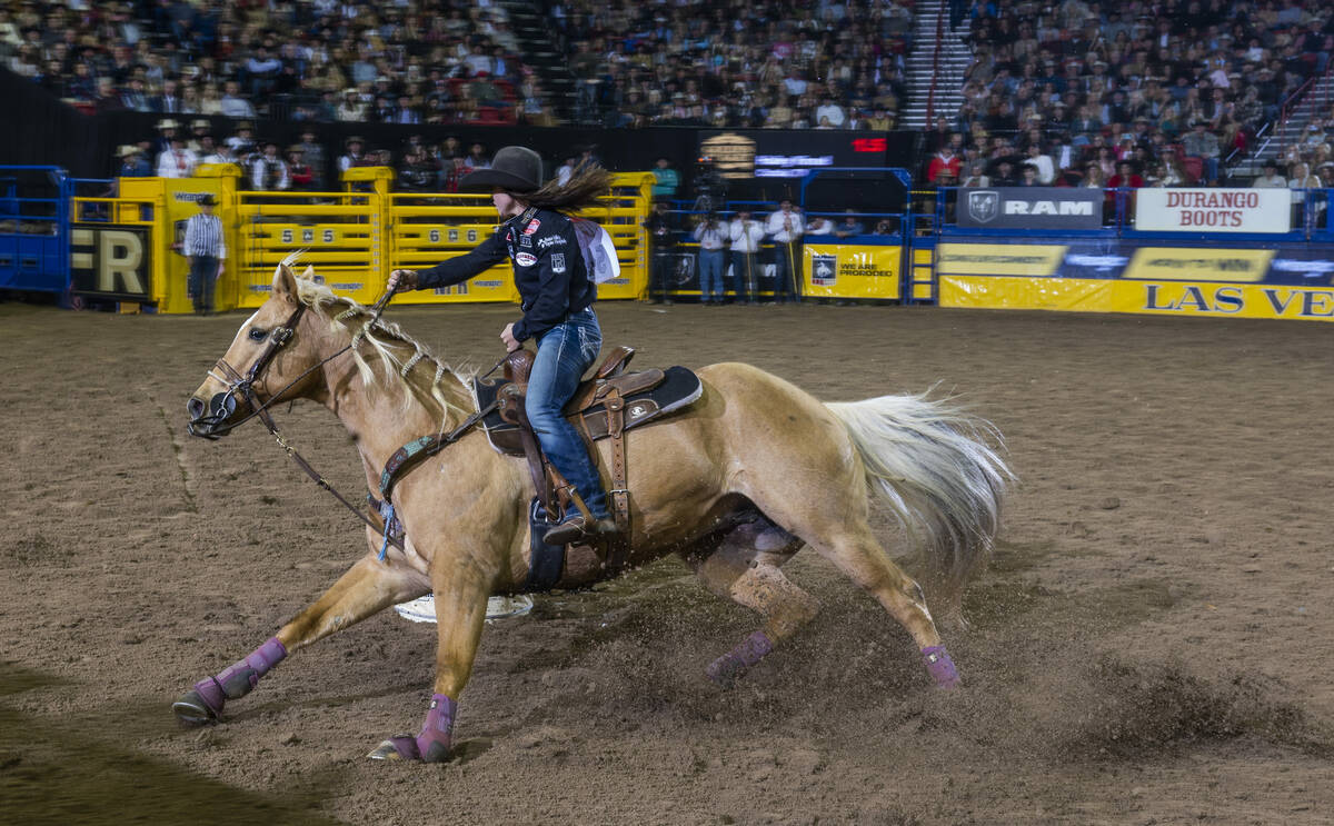 Hailey Kinsel of Cotulla, Texas, navigates a barrel on the way to her winning time in Barrel Ra ...