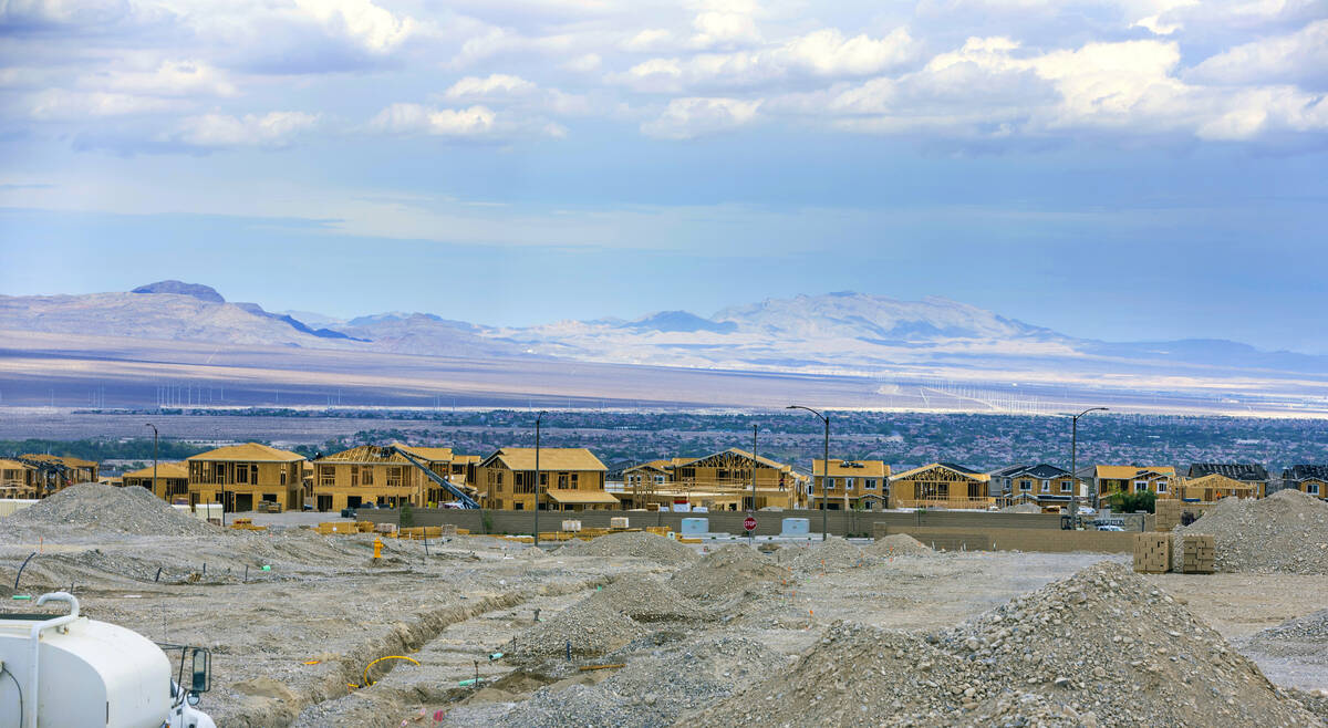 Workers complete framing and walls on new home construction about Skye Canyon on Wednesday, Jul ...