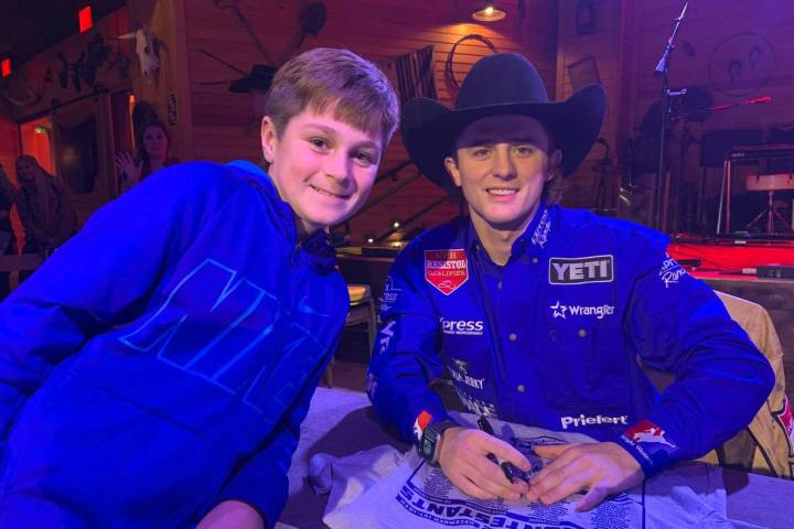 Tayton Sears, left, gets a photo with his favorite rodeo cowboy, three-time defending all-aroun ...