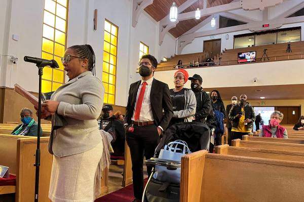 FILE - People line up to speak during a reparations task force meeting at Third Baptist Church ...