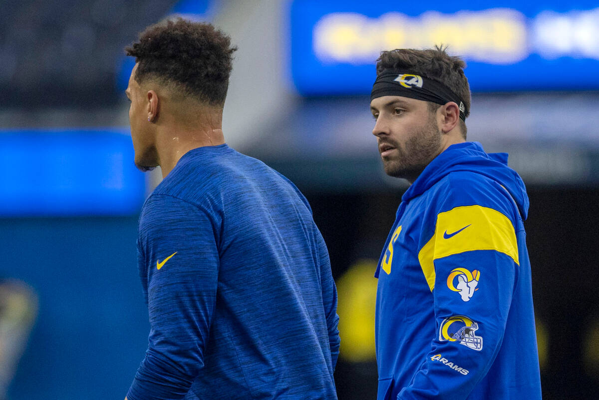 Los Angeles Rams quarterback Baker Mayfield, right, walks the field before an NFL game against ...