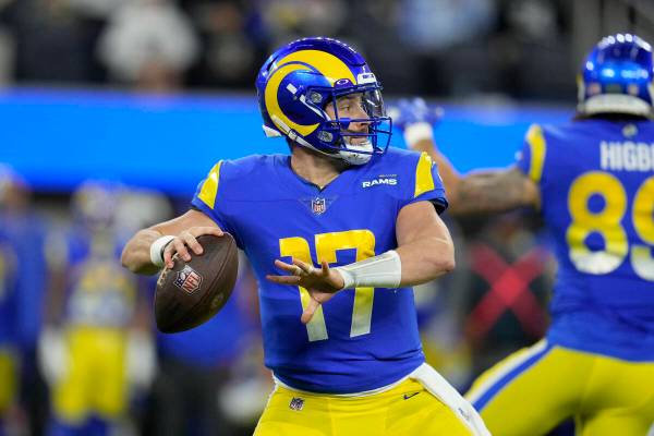 Los Angeles Rams quarterback Baker Mayfield throws a pass during the first half of an NFL footb ...