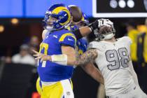 Los Angeles Rams quarterback Baker Mayfield (17) throws as Raiders defensive end Maxx Crosby (9 ...