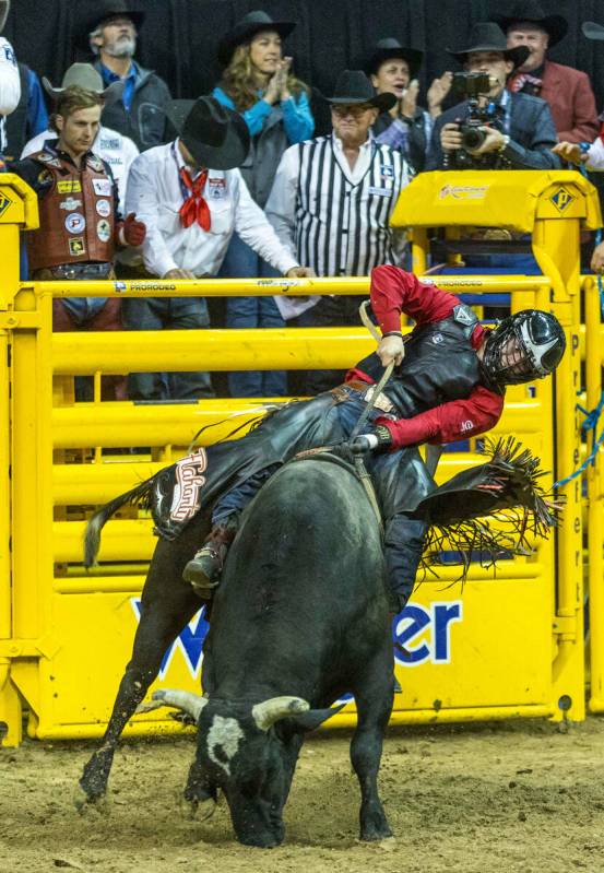 Trey Holston of Fort Scott, KS., hangs tight on his winning ride in Bull Riding during the Nati ...