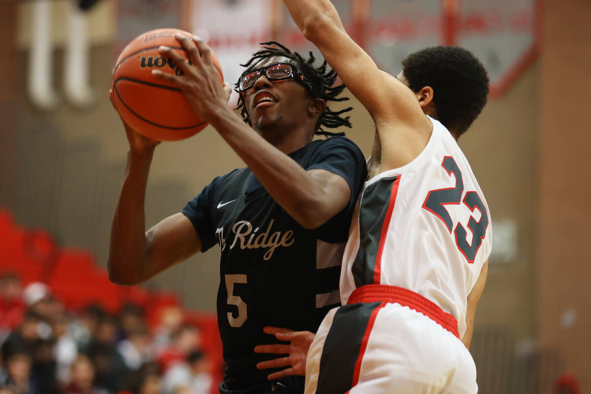 Arbor View's Tony Pabon (23) defends a shot attempt by Shadow Ridge's Ron Flenoy (5) during a b ...