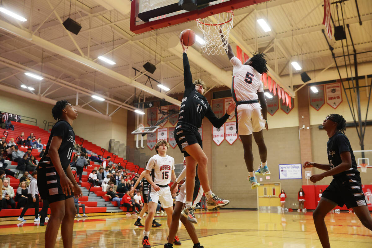 Shadow Ridge's Brock Morrow (11) takes a shot under pressure from Arbor View's Bryce Heckard (5 ...