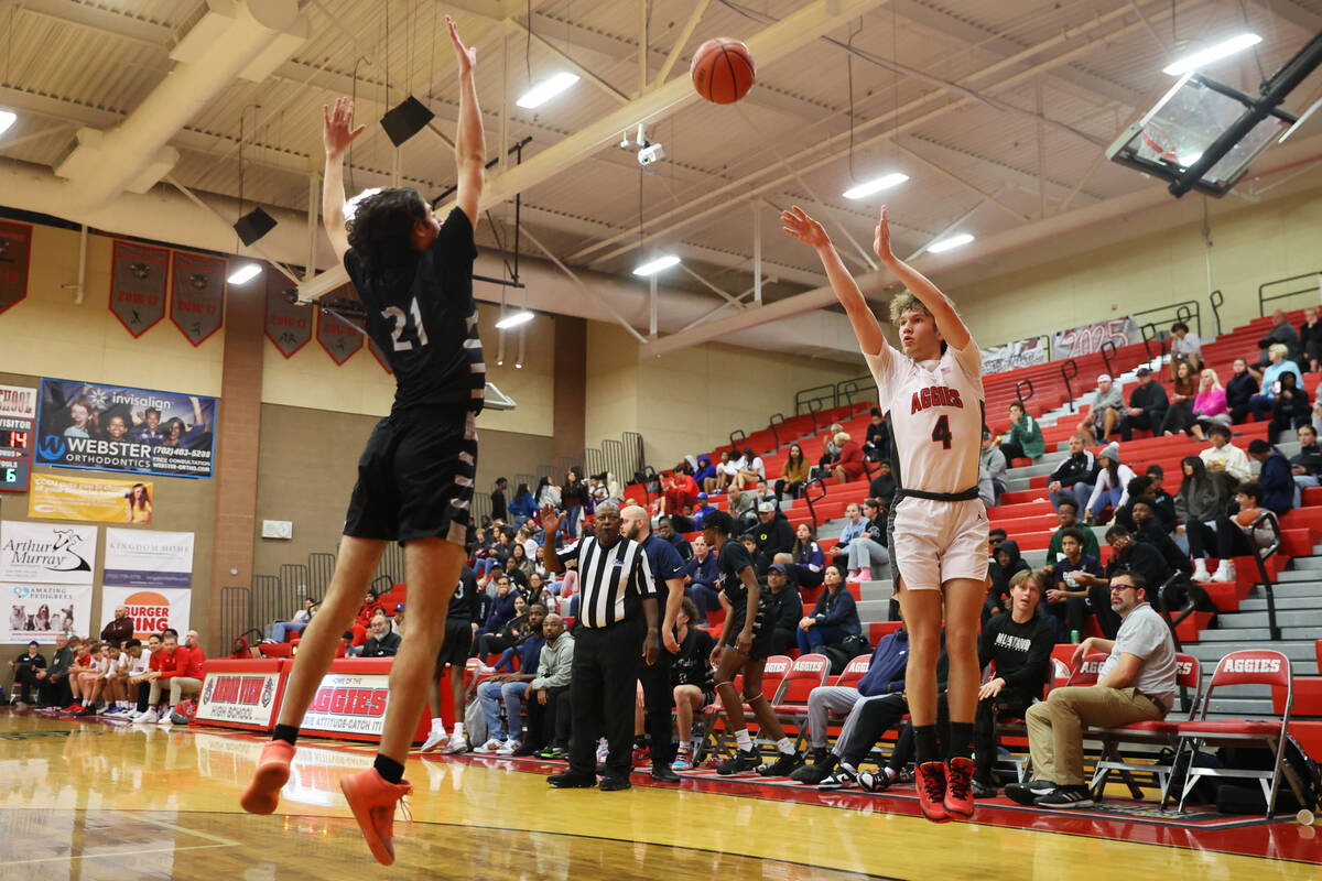 Arbor View's Jalen Dickel (4) takes a shot under pressure from Shadow Ridge's Joseph Martins (2 ...