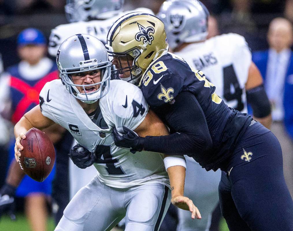 Raiders quarterback Derek Carr (4) is sacked by New Orleans Saints defensive end Payton Turner ...