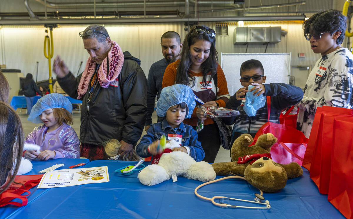 The Bower and Quinones families receive gift bags of stuffed animals to care for as the UMC Lio ...