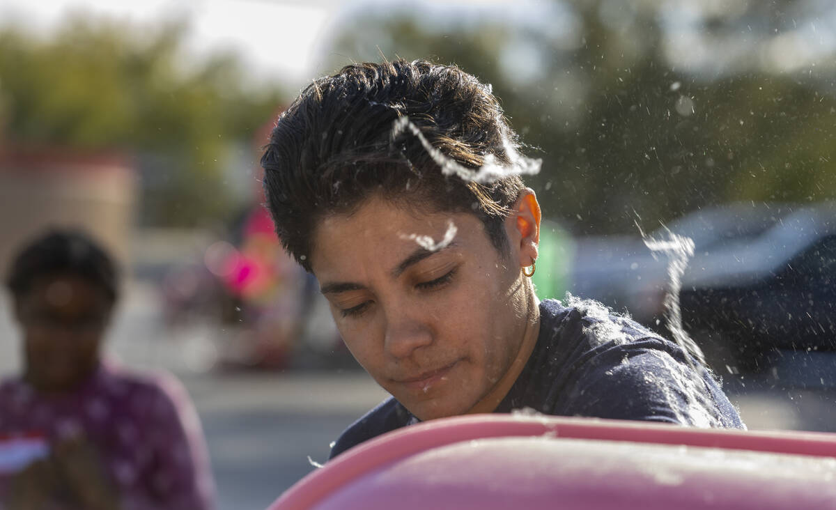 North Las Vegas Fire Explorer Natalia Albarran is covered in cotton candy as she prepares it fo ...