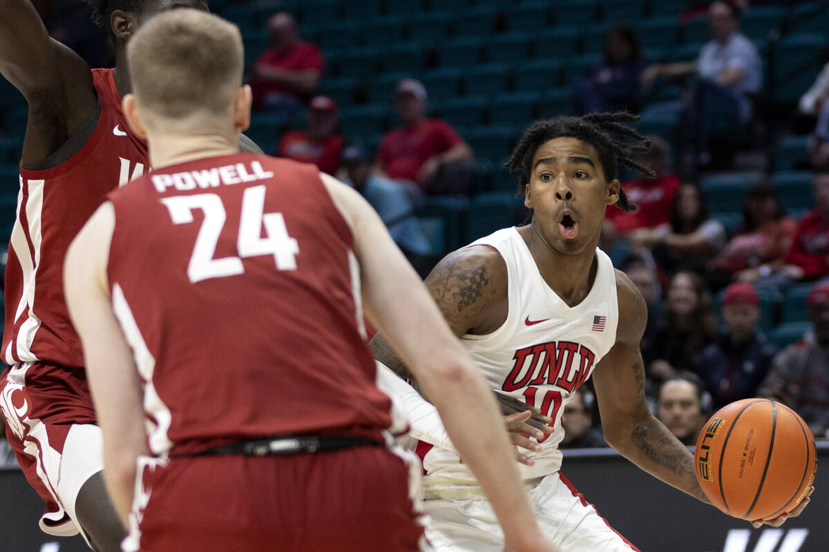 UNLV Rebels guard Keshon Gilbert (10) drives around Washington State Cougars guard Justin Powel ...