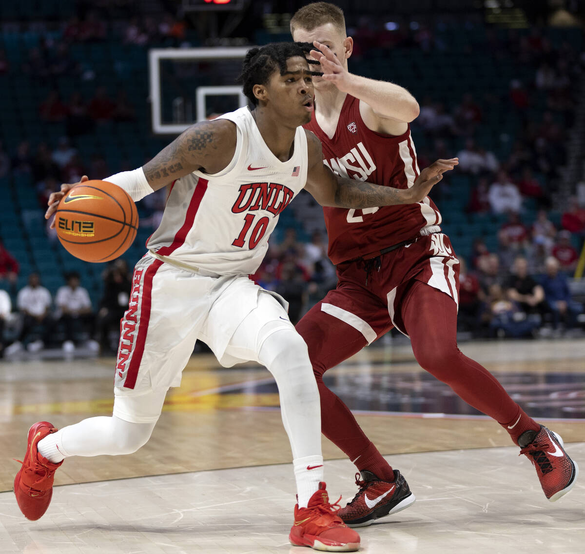 UNLV Rebels guard Keshon Gilbert (10) drives around Washington State Cougars guard Justin Powel ...