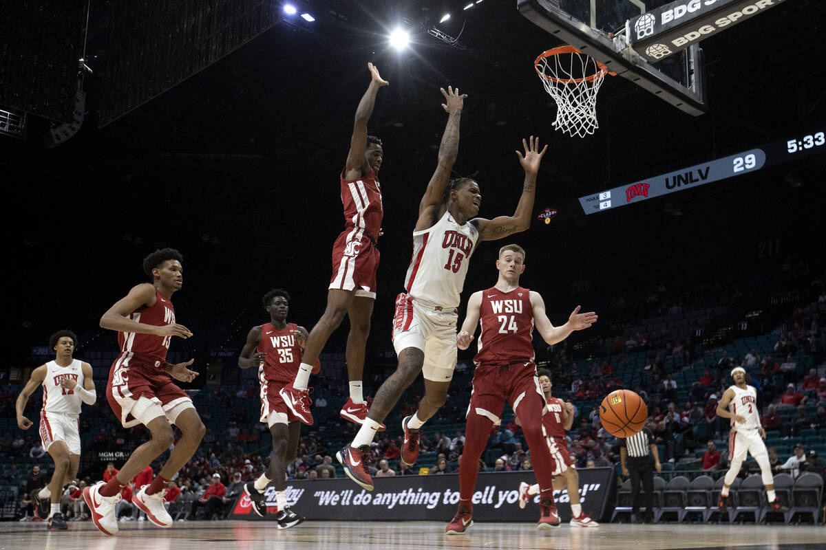 UNLV Rebels guard Luis Rodriguez (15) loses control of the ball while shooting against Washingt ...