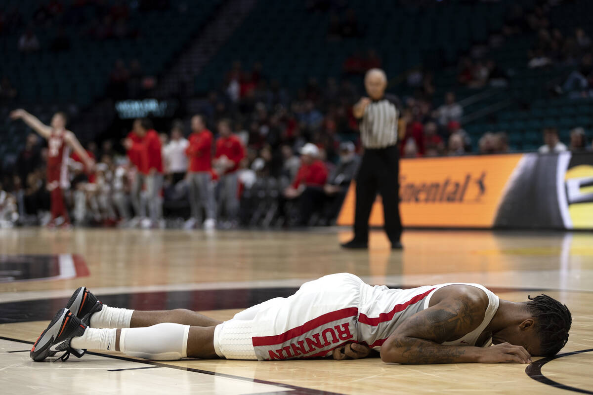 UNLV Rebels guard Elijah Parquet (1) lies on the court after experiencing a knee injury during ...