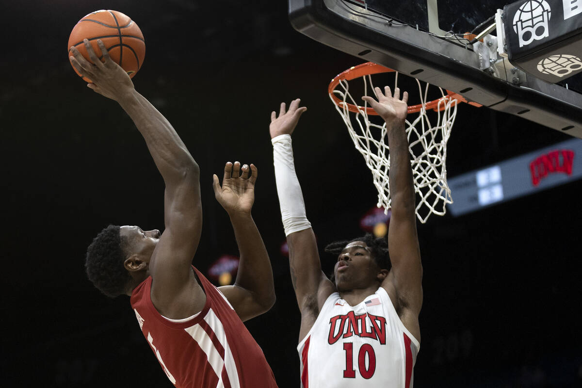 UNLV Rebels guard Keshon Gilbert (10) jumps to block against Washington State Cougars guard TJ ...