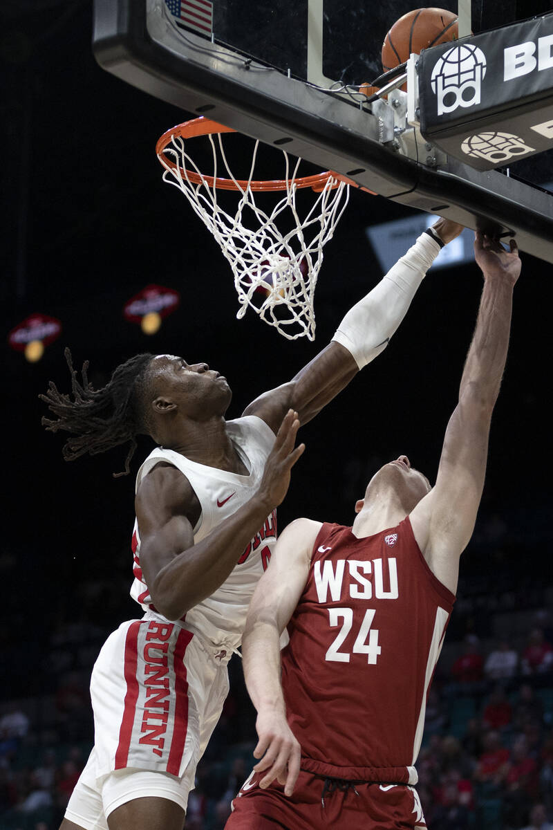 UNLV Rebels forward Victor Iwuakor (0) blocks a shot by Washington State Cougars guard Justin P ...