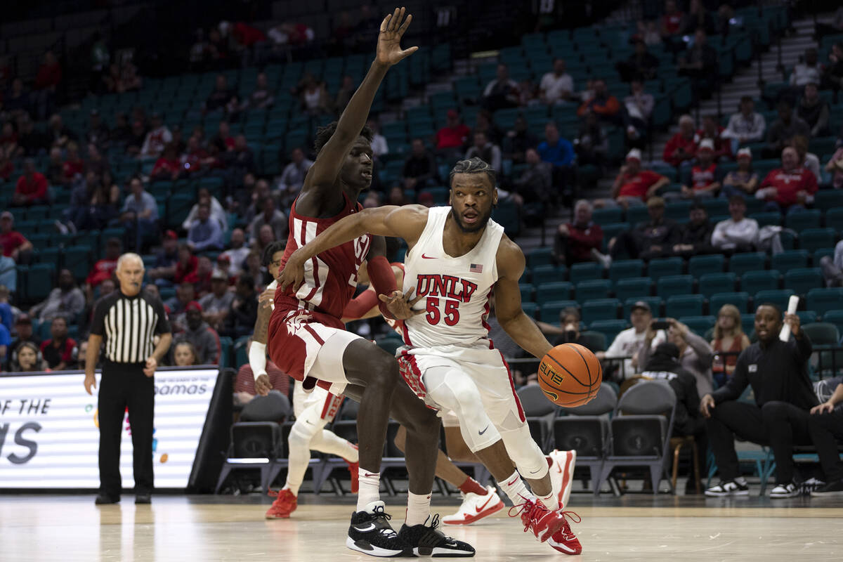 UNLV Rebels guard EJ Harkless (55) drives around Washington State Cougars forward Mouhamed Guey ...