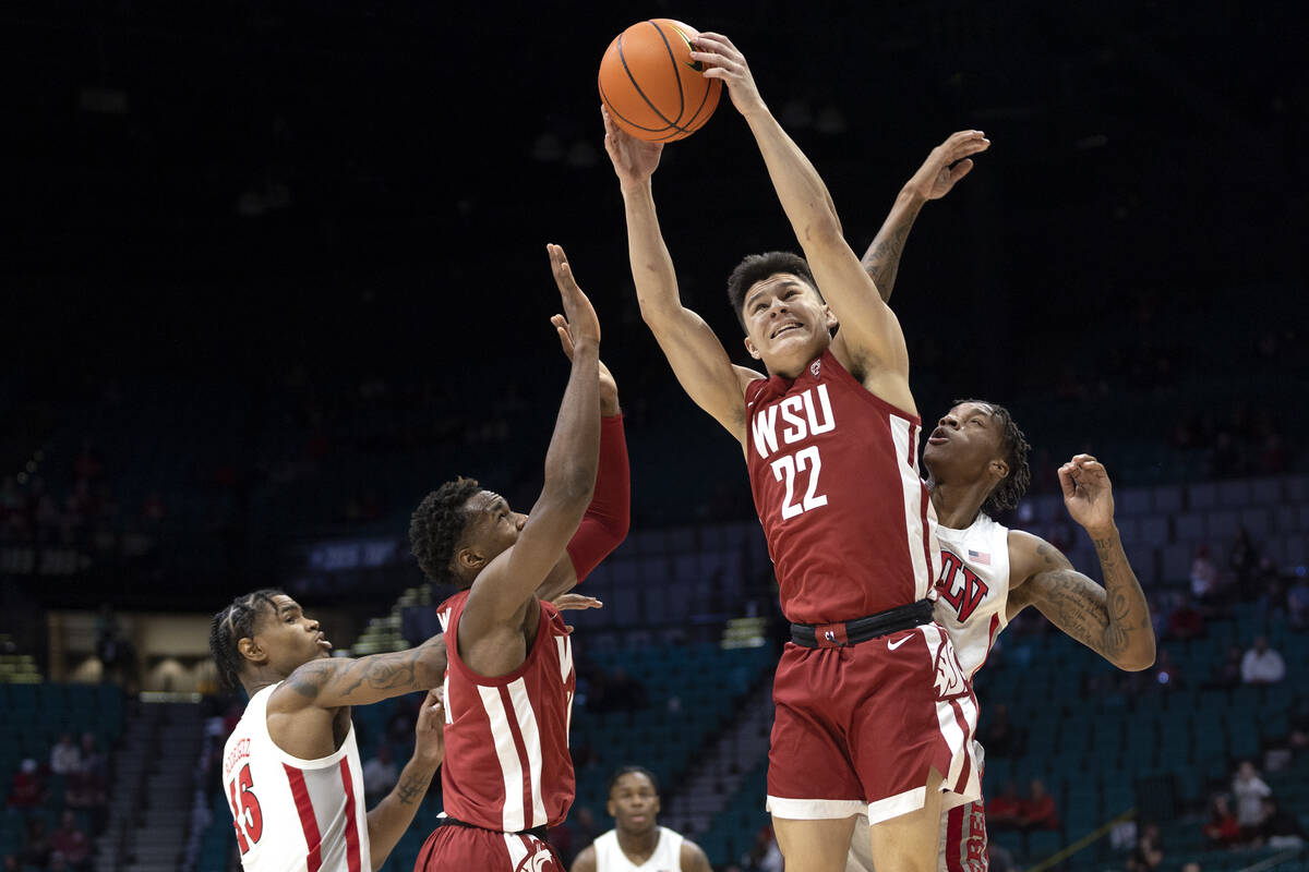 Washington State Cougars guard Dylan Darling (22) jumps for a rebound against UNLV Rebels guard ...