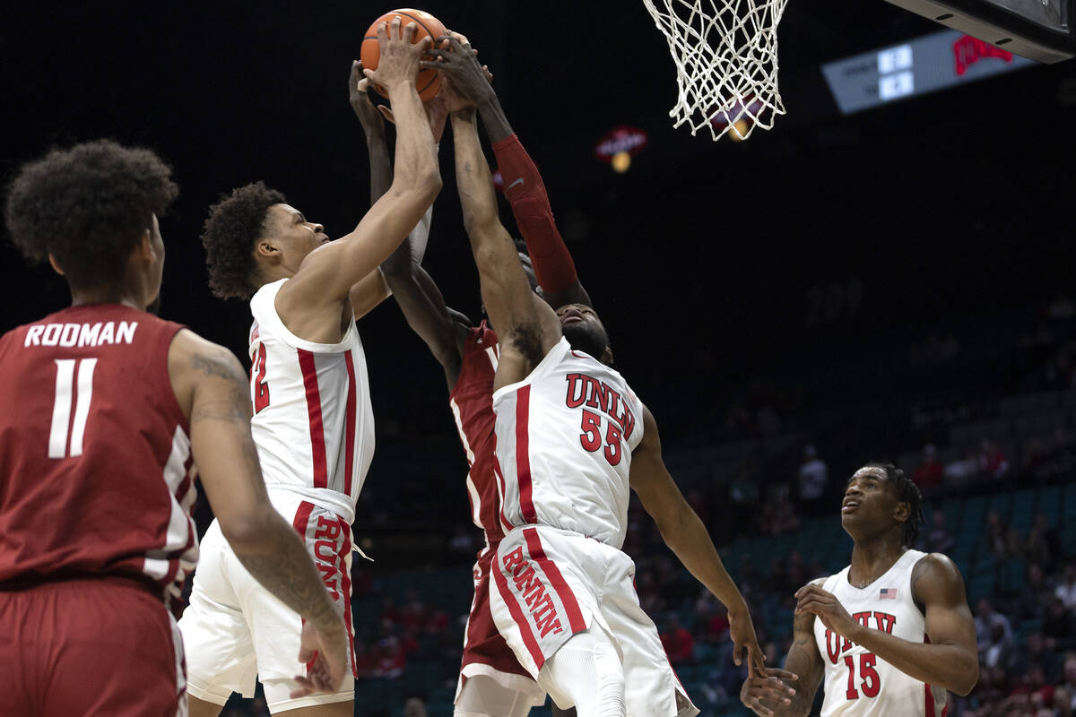 Washington State Cougars forward Mouhamed Gueye, back center, thwarts a shot by UNLV Rebels cen ...