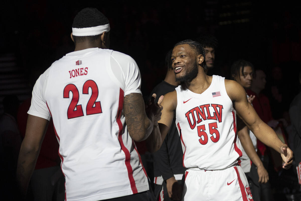 UNLV Rebels guard EJ Harkless (55) slaps hands with forward Karl Jones (22) as his name is call ...