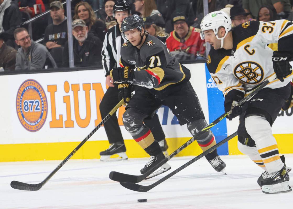 Boston Bruins center Patrice Bergeron (37) skates with the puck under pressure from Golden Knig ...