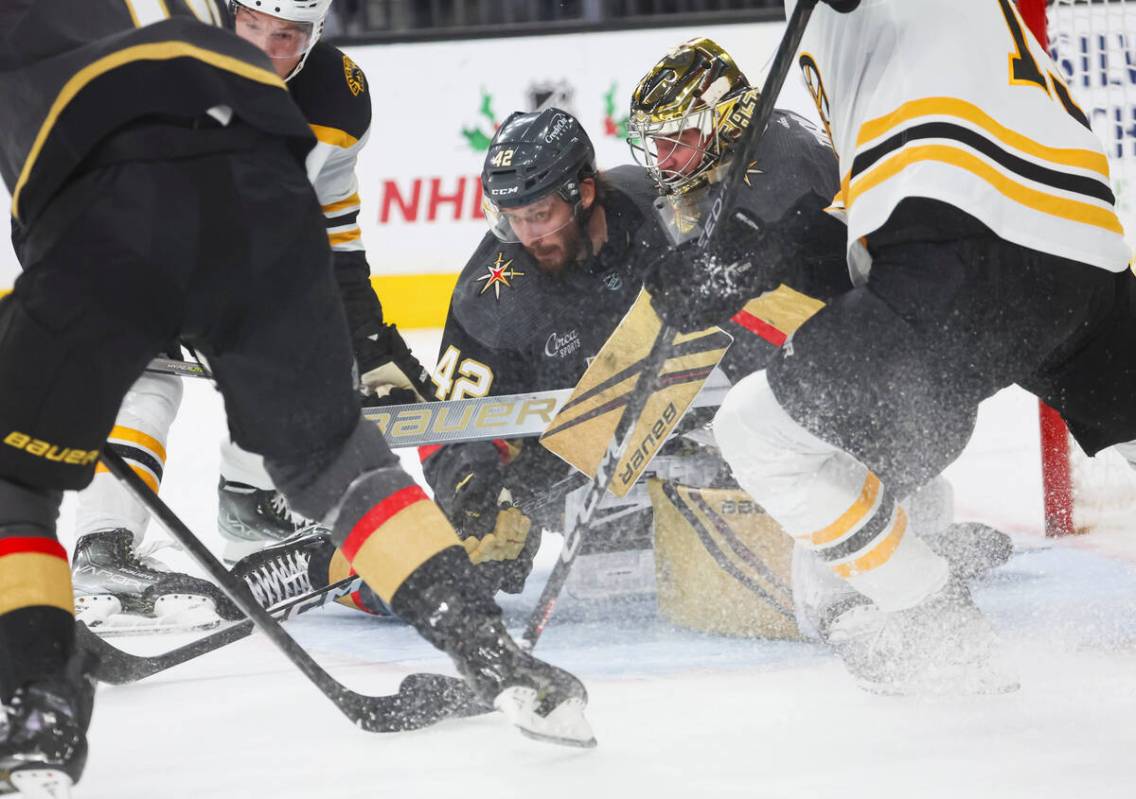 Golden Knights defenseman Daniil Miromanov (42) and goaltender Logan Thompson (36) defend the n ...