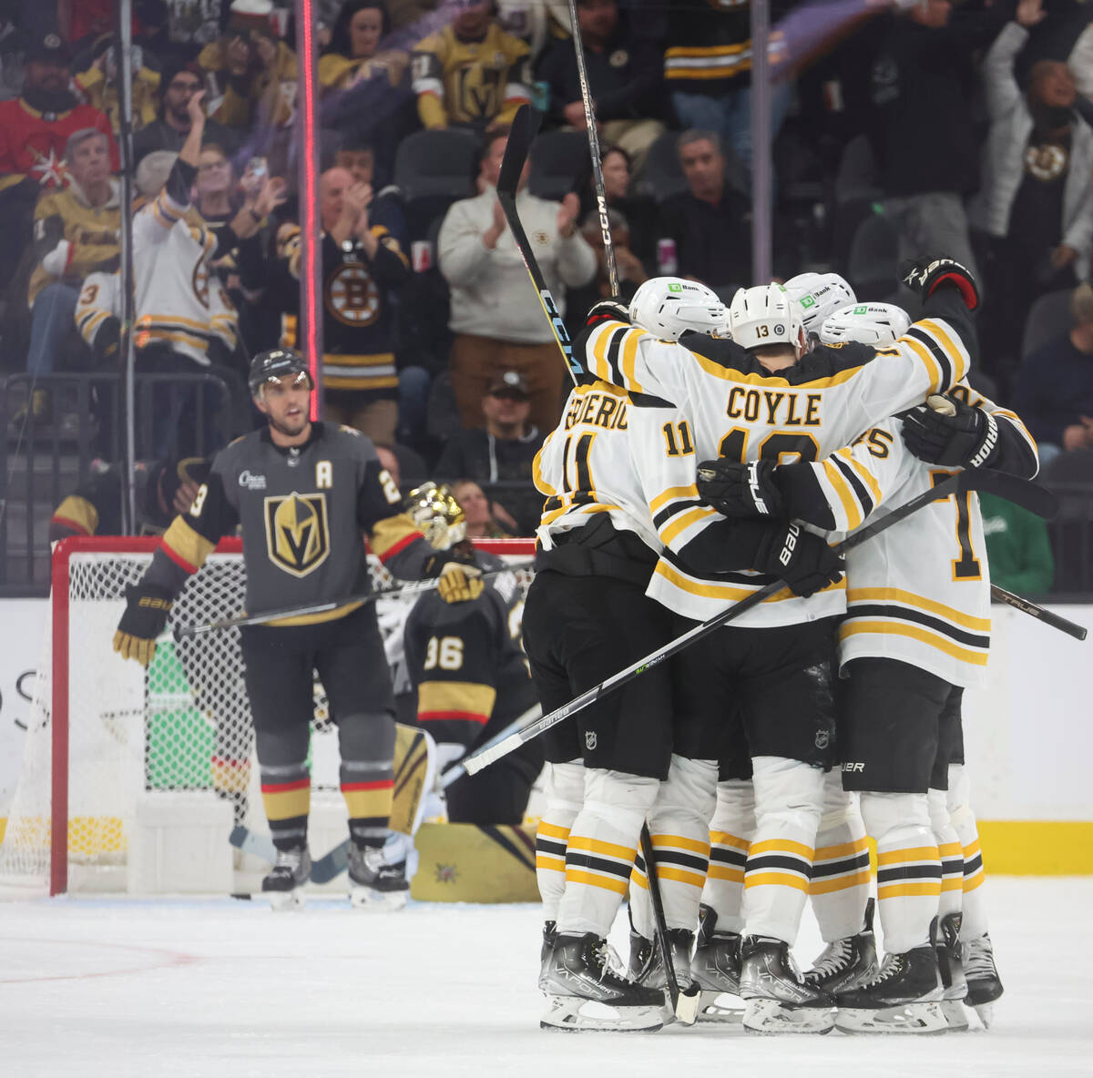 The Boston Bruins celebrate after scoring against the Golden Knights during the third period of ...