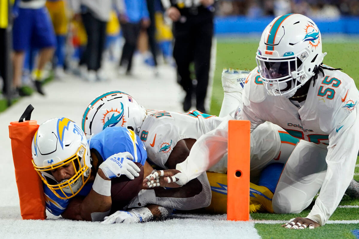 Los Angeles Chargers running back Austin Ekeler is stopped just short of the end zone by Miami ...