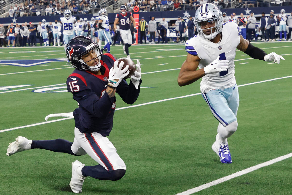 Houston Texans wide receiver Chris Moore (15) makes a catch as Dallas Cowboys cornerback Kelvin ...