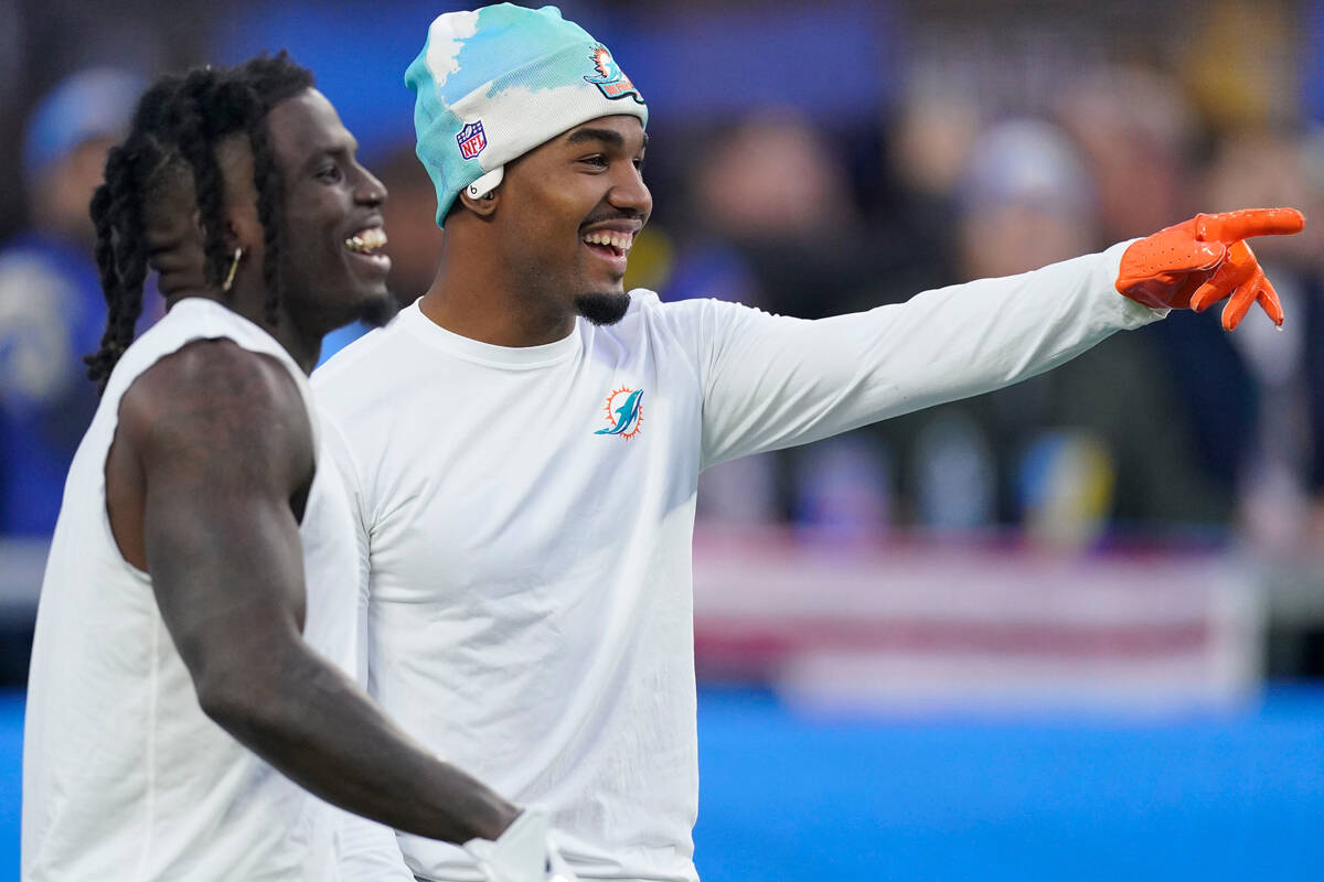 Miami Dolphins wide receiver Tyreek Hill, left, and wide receiver Jaylen Waddle smiles on the f ...