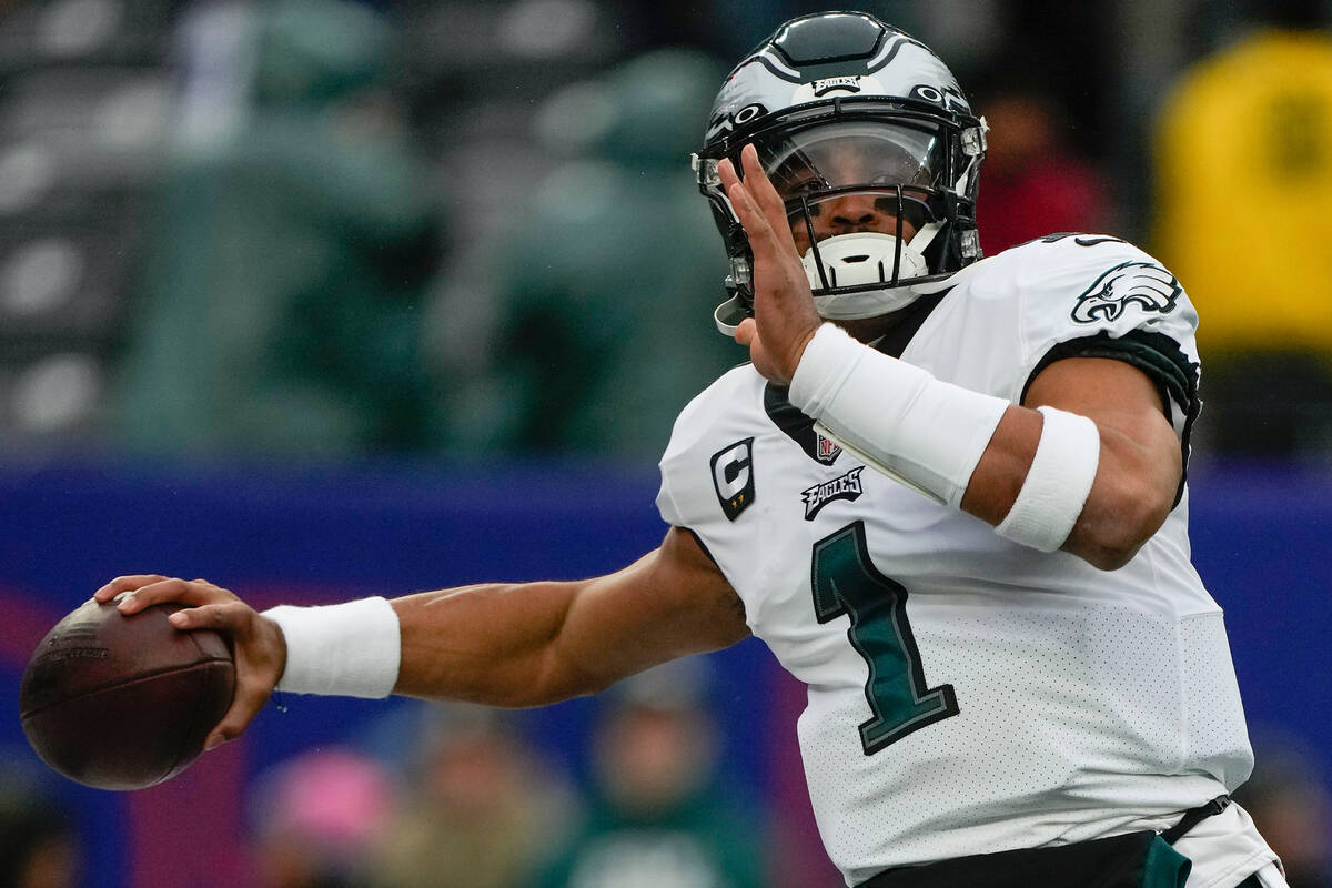 Philadelphia Eagles quarterback Jalen Hurts (1) warms up before an NFL football game against th ...