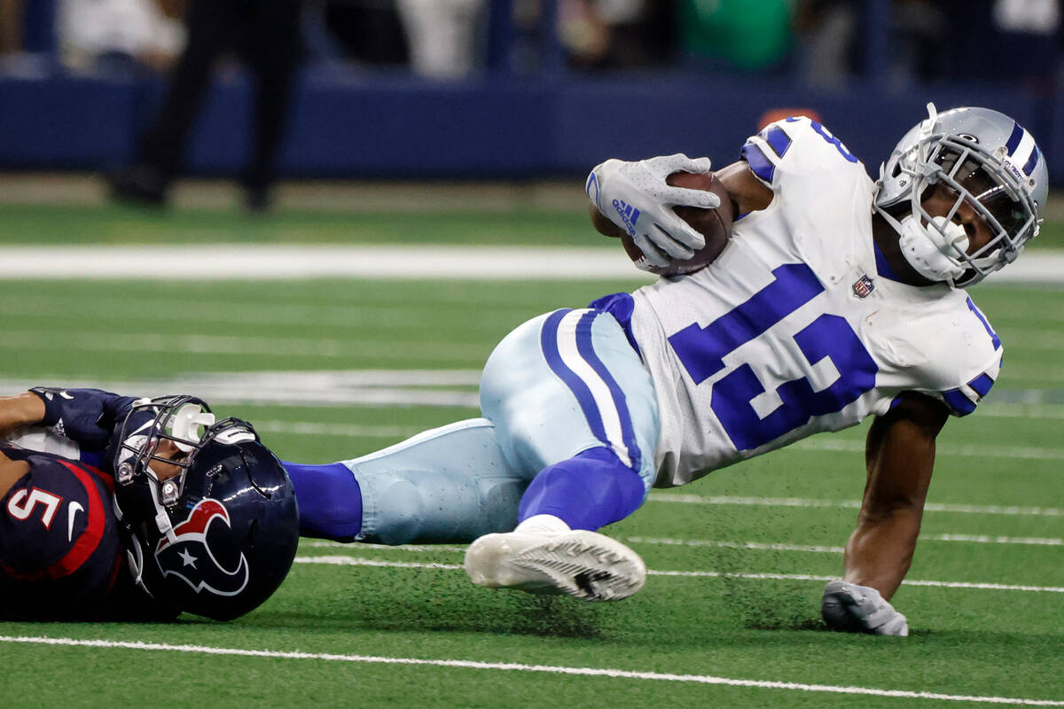 Dallas Cowboys wide receiver Michael Gallup (13) is stopped by Houston Texans safety Jalen Pitr ...