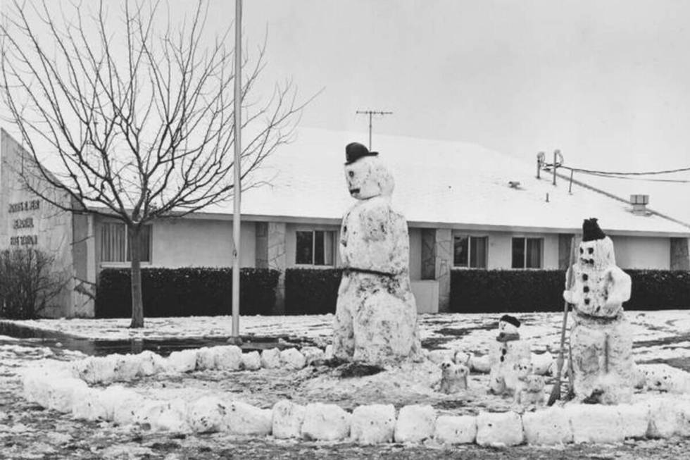 A family of snowmen stand on the lawn at the Morris R. Weir Memorial Fire Station in North Las ...