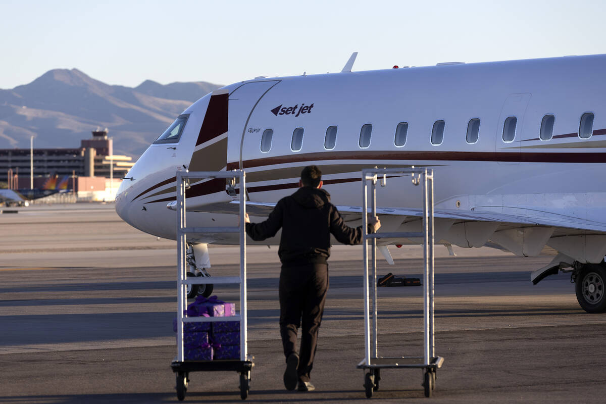 An employee heads to greet passengers on a Set Jet flight during a groundbreaking event for the ...